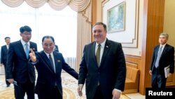 Secretary of State Mike Pompeo, right, and Kim Yong Chol, left, a North Korean senior ruling party official and former intelligence chief, arrive for a lunch at the Park Hwa Guest House in Pyongyang, North Korea