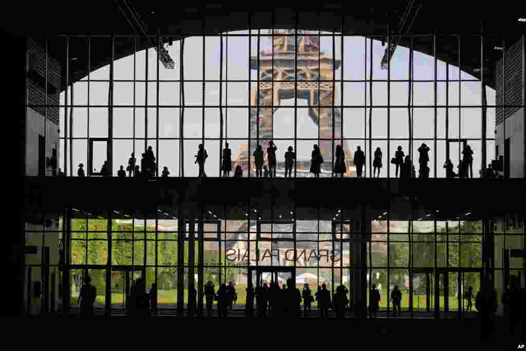 Visitors gather during a presentation visit of the &quot;Grand Palais Ephemere&quot;, with the Eiffel Tower seeing outside, in Paris, France.