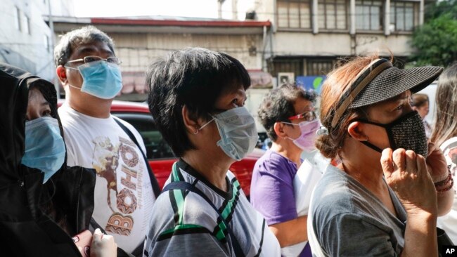 2020年1月30日，人们在菲律宾首都马尼拉一商店前排队购买口罩。（美联社）