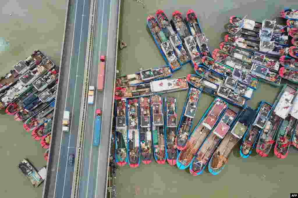 This aerial image shows fishing boats docked on the last day of the summer fishing moratorium, as they prepare to leave port in Lianyungang in eastern China's Jiangsu province.