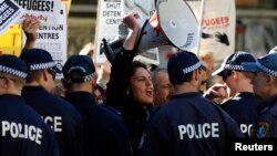 A man shouts slogans against the Australian Labor Party (ALP) during a rally in support of asylum seekers outside an ALP meeting in Sydney, July 22, 2013. 