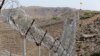 FILE - A view of the border fence outside the Kitton outpost on the border with Afghanistan in North Waziristan, Pakistan, Oct. 18, 2017.