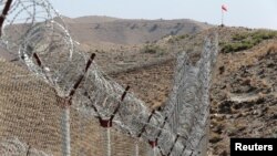 FILE - A view of the border fence outside the Kitton outpost on the border with Afghanistan in North Waziristan, Pakistan, Oct. 18, 2017.