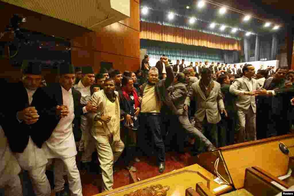 Constitution assembly members shout slogans during a meeting at the parliament on the final day to draft the new constitution in Kathmandu, Nepal.