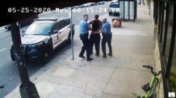 FILE - Minneapolis police Officers Thomas Lane, left, and J. Alexander Kueng, right, escort George Floyd, center, to a police vehicle outside Cup Foods in Minneapolis, on May 25, 2020, in this image from video.