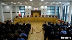 FILE - Judges of Poland's Constitutional Court attend a session at the Constitutional Tribunal in Warsaw.