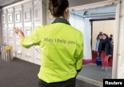 Passengers check in at Brussels Airport, which partially re-opened following a bomb blast 12 days ago, in Zaventem, Belgium, April 3, 2016.