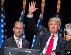 In this July 21, 2016, photo, then-Republican presidential candidate Donald Trump waves during a walk through at the Republican National Convention, July 21, 2016, in Cleveland, as Rick Gates watches.