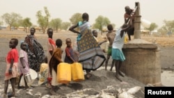 FILE - Internally displaced people collect water from a borehole at a camp near Kodok in the north-eastern South Sudanese state of Western Nile, April 17, 2017.