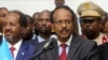 Somalia's newly elected President Mohamed Abdullahi Farmajo flanked by outgoing president Hassan Sheikh Mohamud (L) addresses lawmakers after winning the vote at the airport in Somalia's capital Mogadishu, Feb. 8, 2017.