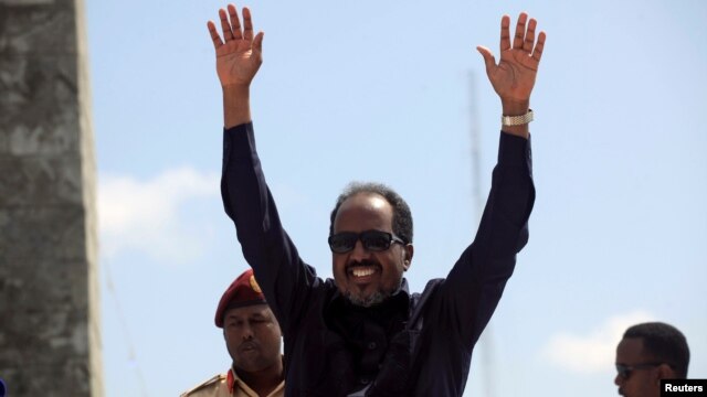 Somalia's President Hassan Sheikh Mohamud waves to the guests as he arrives for Independence Day celebrations outside the ruins of the former parliament buildings in Somalia's capital, Mogadishu, July 1, 2016.