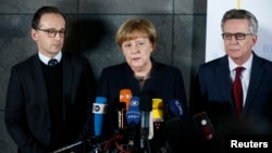 FILE - German Chancellor Angela Merkel, Justice Minister Heiko Maas, left, and Interior Minister Thomas de Maiziere are pictured while making a statement after visiting the Bundeskriminalamt Federal Crime Office Police in Berlin, Dec. 22, 2016.