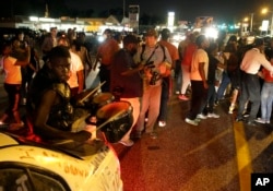 For a fifth night, protesters gather along West Florissant Avenue to protest the killing of Michael Brown a year ago, in Ferguson, Mo., Aug. 11, 2015.