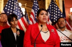 FILE - Immigration activist Astrid Silva (in red) stands next to her mother, Barbara Silva, as she speaks about immigration reform at a news conference on Capitol Hill in Washington, Dec. 10, 2014. Astrid Silva will be one of the speakers on the opening night of the 2016 Democratic National Convention.