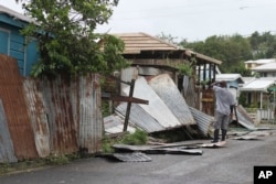 A man surveys the wreckage on his property after the passing of Hurricane Irma, in St. John's, Antigua and Barbuda, Sept. 6, 2017.