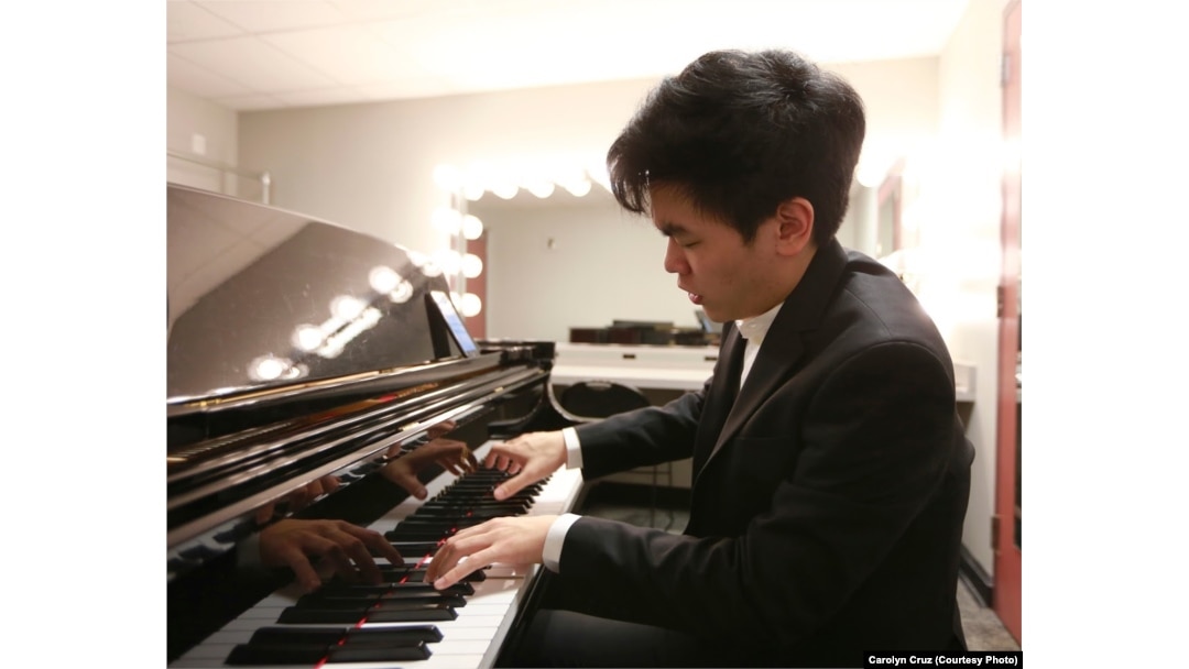 Daniel Hsu of the United States warms up in his dressing room before performing his Thursday evening recital in the Semifinal Round at the 15th Van Cliburn International Piano Competition.