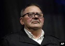 Jozef Kuciak, father of the murdered journalist Jan Kuciak attends during a rally to mark one year anniversary of the slayings of his son and his fiancee, in Bratislava, Slovakia, Feb. 21, 2019.