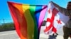 FILE - Georgian LGBT activists attend a rally against homophobia outside the State Chancellery to mark international day against homophobia, in downtown Tbilisi, Georgia, Wednesday, May 17, 2017.