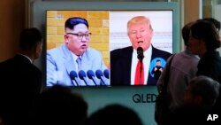 FILE - People watch a TV screen showing file footage of U.S. President Donald Trump, right, and North Korean leader Kim Jong Un during a news program at the Seoul Railway Station in Seoul, South Korea, April 21, 2018.