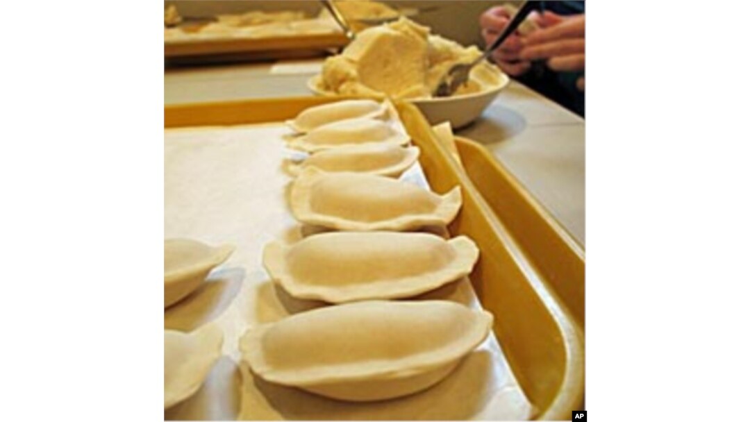 Volunteers scoops out the smooth potato filling to make tray after tray of hand-shaped pierogies in time for Orthodox Christmas.