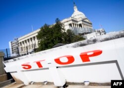 FILE - The U.S. Capitol is seen closed off by a road barrier, during a partial government shutdown in Washington, Dec. 27, 2018.