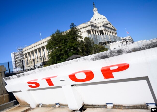 FILE - The U.S. Capitol is seen closed off by a road barrier, during a partial government shutdown in Washington, Dec. 27, 2018.