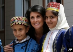 U.S. Ambassador to the U.N. Nikki Haley, center, poses for pictures with Syrian refugee children at the Sakirpasa Umran school, funded by the US government, during its opening ceremony in Adana, southern Turkey, May 24, 2017.
