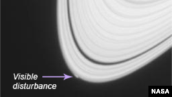 Saturn, with notation showing location of visible disturbance on outer rings. (NASA)
