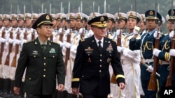 Joint Chiefs Chairman Gen. Martin Dempsey, right, and Chinese counterpart Gen. Fang Fenghui inspect a guard of honor during a welcoming ceremony at the Bayi Building in Beijing, China, April 22, 2013. 