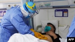 တရုတ်နိုင်ငံက ကိုရိုနာဗိုင်းရပ်စ်ကူးစက်ခံရသူကို ဆေးဝန်ထမ်း တဦးက စမ်းသပ်နေစဉ် (ဇန်နဝါရီ၊ ၂၈၊ ၂၀၂၀)