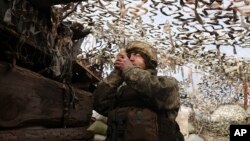 A Ukrainian soldier at a fighting position on the line of separation from pro-Russian rebels near Debaltsevo, Donetsk region, Ukraine, Ukraine, Dec 3, 2021. 