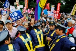 Thousands of Japanese protested outside the parliament in Tokyo, against a set of security bills designed to expand the role the country's military.
