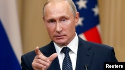 Russian President Vladimir Putin gestures during a joint news conference with U.S. President Donald Trump (not pictured) after their meeting in Helsinki, Finland July 16, 2018.