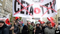 FILE - Protesters march against trade deals with Canada and the U.S. in Warsaw, Poland, Oct. 15, 2016. Hundreds of people in the Polish capital are protesting free-trade agreements the European Union is pursuing with the U.S. and Canada, TTIP and CETA. The deal is being held up by one small region of Belgium.