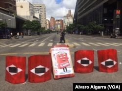 A street is blockaded during a strike in Caracas, Venezuela, July 26, 2017. The sign reads "fraudulent."