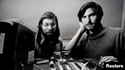Apple co-founders Steve Jobs and Steve Wozniak are seen working together in this undated photo.
