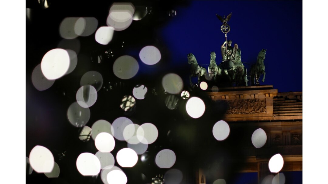 A Christmas tree is illuminated in front of Brandenburg Gate in Berlin, Germany, November 26, 2020. REUTERS/Hannibal Hanschke TPX IMAGES OF THE DAY