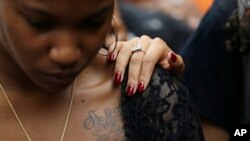 Students at the University of North Carolina-Charlotte comfort one another during a vigil following Tuesday's fatal police shooting of Keith Lamont Scott at The Village at College Downs apartment complex in Charlotte, N.C., Sept. 21, 2016.