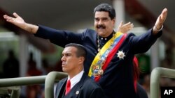 Venezuela's President Nicolas Maduro holds out his arms as arrives to attend a military parade commemorating the country's Independence Day in Caracas, Venezuela, July 5, 2017.