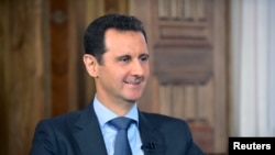 Syria's President Bashar al-Assad answers questions during an interview with al-Manar's journalist Amro Nassef, in Damascus, Syria, in this photograph handed out by Syria's national news agency SANA on Aug. 25, 2015. 