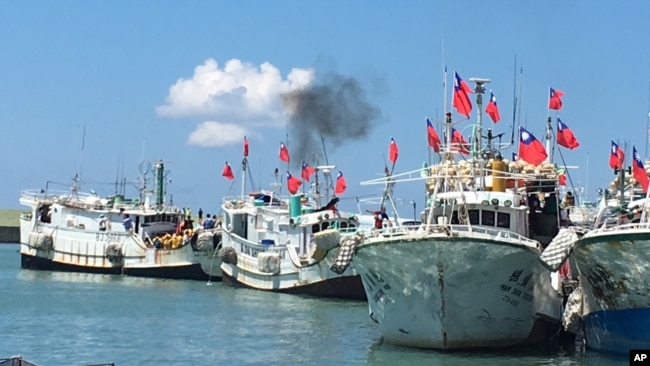 Taiwanese fishing boats flying national flags prepare to leave for Taiping Island in 2016. Taiwan and China have disputing claims in the South China Sea.