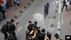 Turkish police officers fire tear gas and rubber bullets to disperse demonstrators who gathered for a gay pride rally despite a government ban, off Istiklal Avenue, central Istanbul's main shopping road, Sunday, June 19, 2016.