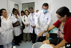 FILE - A group of Cuban doctors attend a training session at a health clinic in a low-income neighborhood in Brasilia, Brazil, Friday, Aug. 30, 2013.