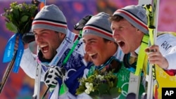 Men's ski cross gold medalist Jean Frederic Chapuis of France, center, celebrates with silver medalist Arnaud Bovolenta of France, left, and bronze medalist Jonathan Midol of France, at the Rosa Khutor Extreme Park, at the 2014 Winter Olympics, Thursday,