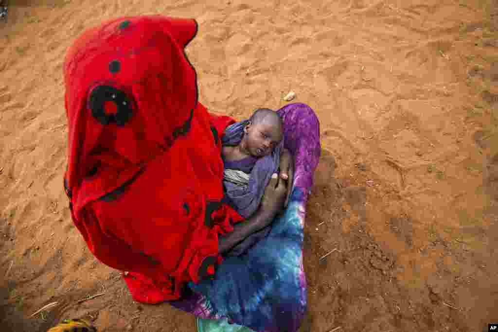 Sara Alisio and her one-month old child Molide Kelbi wait for food and water in the Warder district in the Somali region of Ethiopia, Jan. 28, 2017.