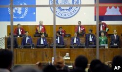 FILE - Judges arrive at the Extraordinary Chambers in the Courts of Cambodia in Phnom Penh, Cambodia, as the trial for former Khmer Rouge prison commander Kaing Guek Eav, also know as "Duch" begins Tuesday, Feb. 17, 2009, in Phnom Penh, Cambodia.