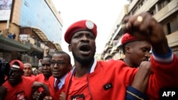 FILE - Musician turned politician Robert Kyagulanyi, aka Bobi Wine, is joined by other activists in Kampala, July 11, 2018. Kyagulanyi was among the opposition legislators who were arrested Monday, then reportedly tortured by security forces.