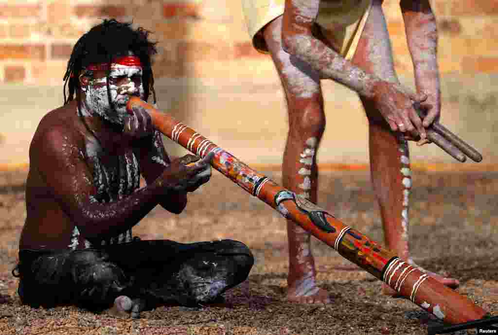 Aboriginal performer known as &#39;Turtle&#39; plays a didgeridoo as he participates in a ceremony with fellow performer Terry Olsen to mark the start of National Reconciliation Week for Aboriginal and Torres Strait Islanders in Sydney, Australia.