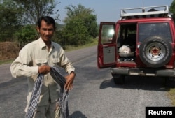 FILE - Chut Wutty, Director of the Natural Resource Protection Group, walks in Koh Kong province, Feb. 20, 2012. The prominent anti-logging activist, who helped expose a secretive state sell-off of national parks, was fatally shot on April 25, 2012 in a remote southwestern province, said police.