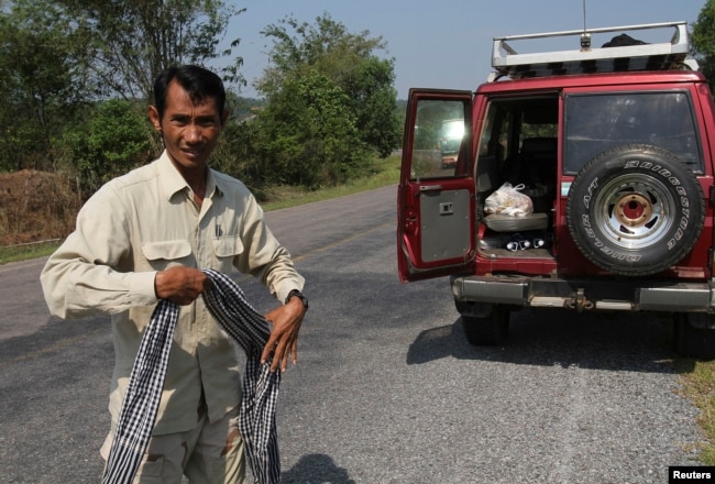 FILE - Chut Wutty, Director of the Natural Resource Protection Group, walks in Koh Kong province, Feb. 20, 2012.